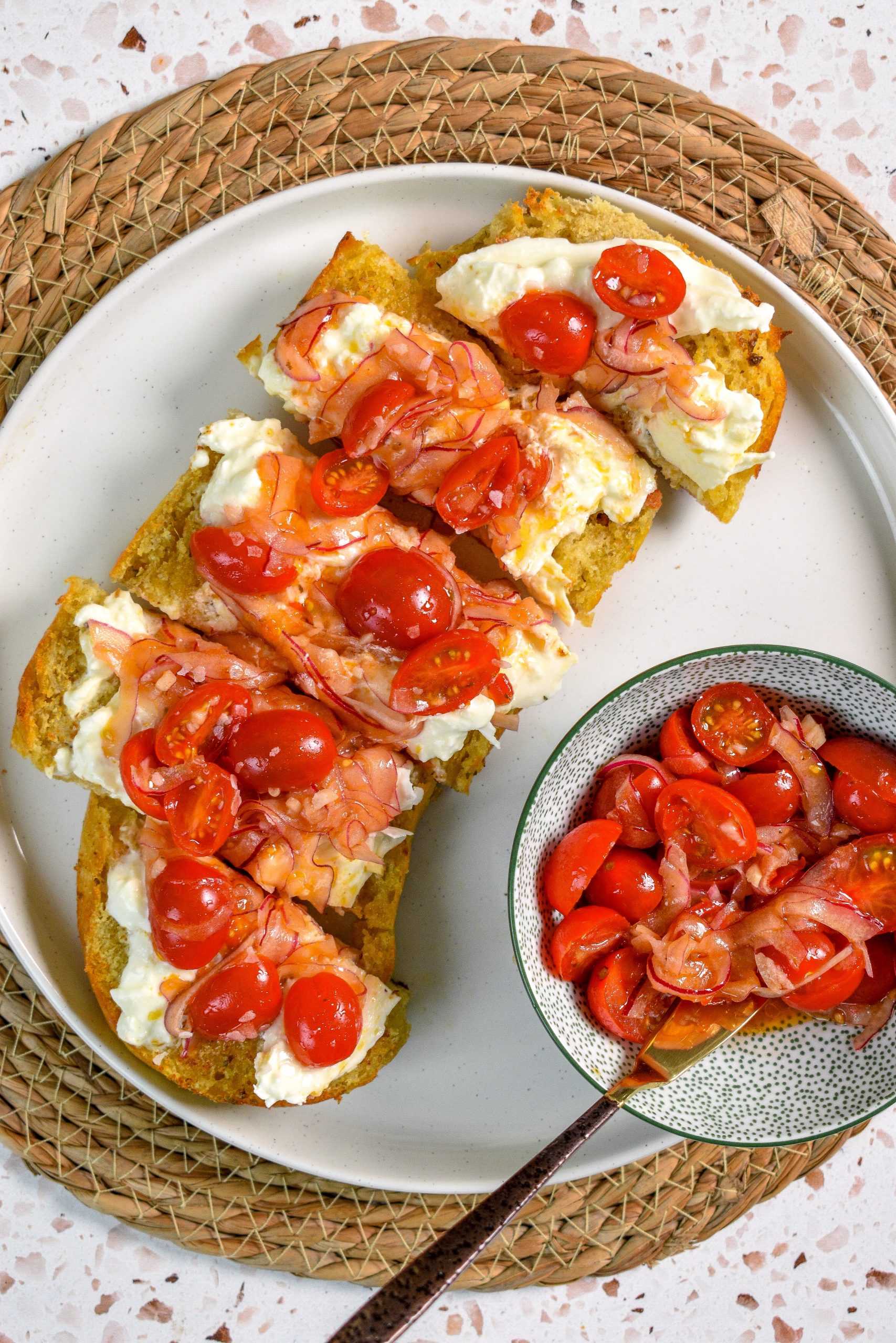 This is an image of calabrian chili salad and burrata on toasted garlic bread.