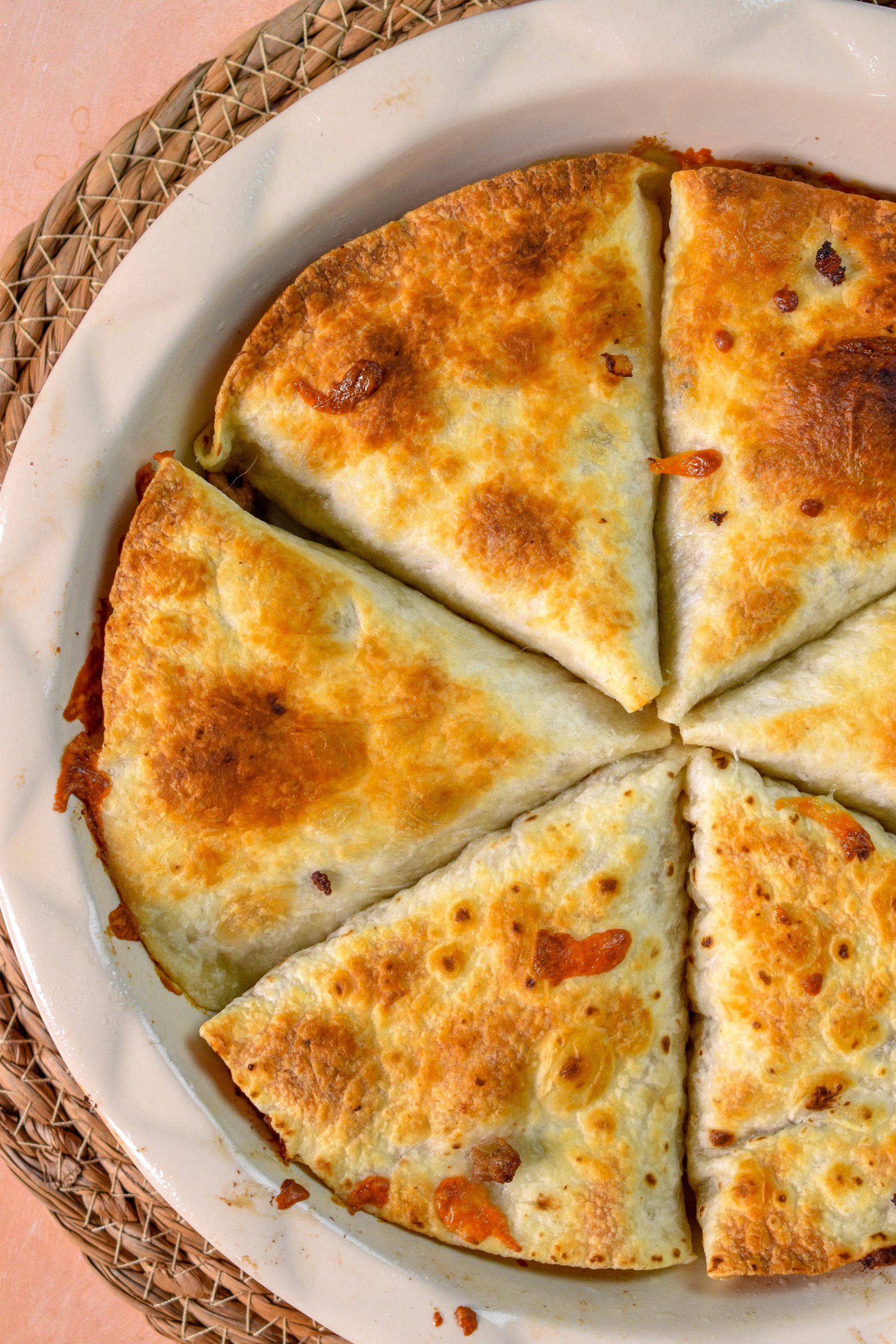 This is an image of tortilla cheeseburger pockets in a baking dish