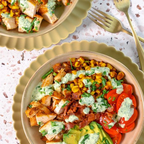 This is an image of a blt chicken bowl with charred corn topped with basil ranch